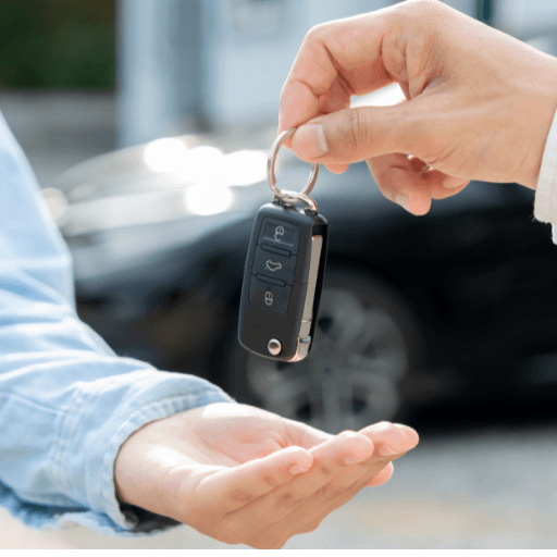 Car keys being handed over during a rental delivery